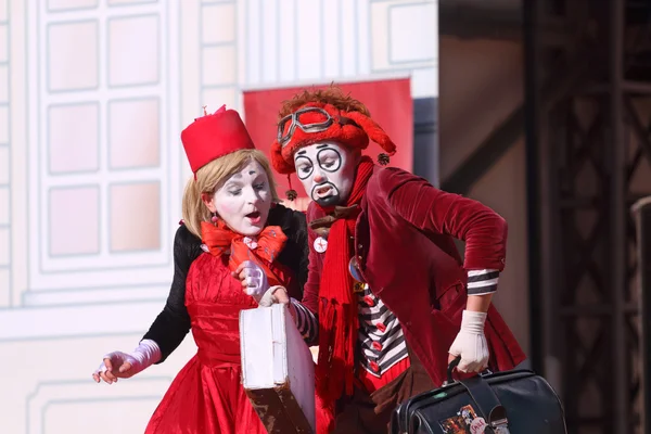 Two clowns perform on open air stage