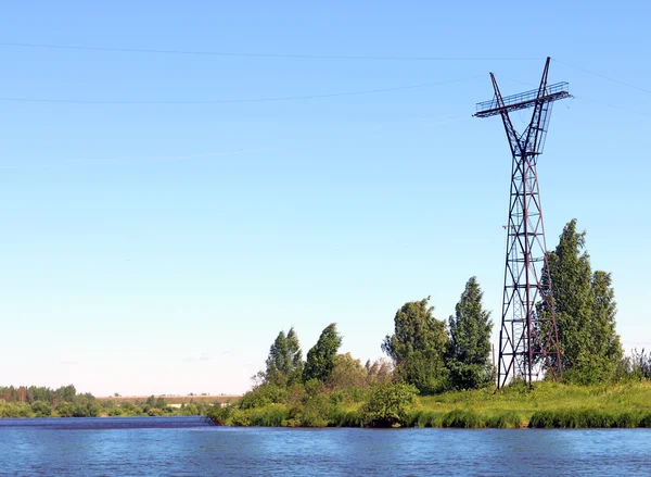 River coast line with green grass and power transmission line