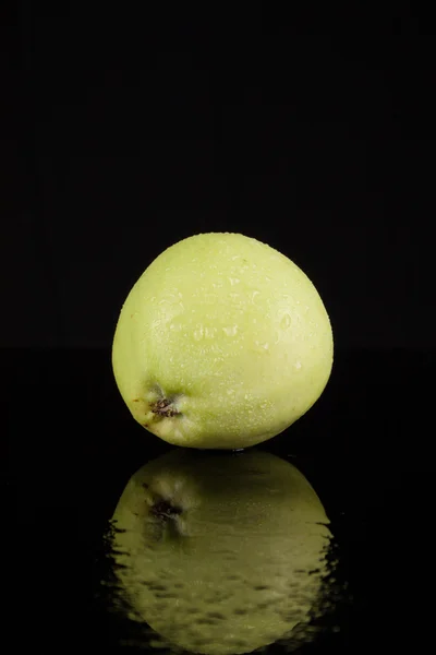 Summer green apples on a black background