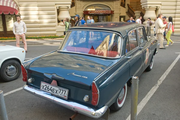 Soviet car Moskvich-408 on retro rally Gorkyclassic in the Parking lot near Gum Department store, Moscow, rear view