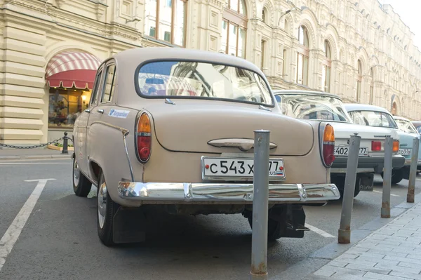 Soviet retro car Moskvich-403 on retro rally Gorkyclassic in the Parking lot near Gum Department store, Moscow, rear view