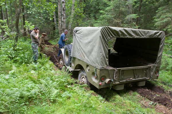 Old military retro car Dodge WC-51 stuck in the woods, 3rd international meeting \