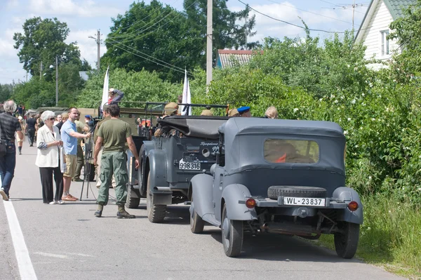 A column of military retro cars on the side of the road, the 3rd international meeting of \