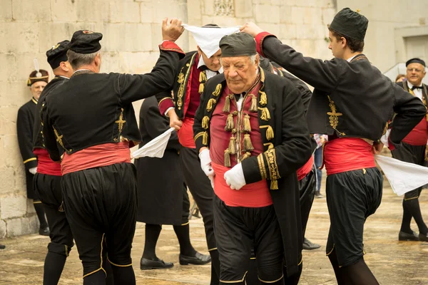Perast, Montenegro - May 15, 2016: Shooting the Kokot (rooster) celebration. Celebrates the liberation of Perast from Turkish in 1654. Theatrical performance on a city street. Dance with hankerchief.
