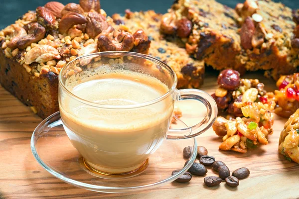 Cup of delicious coffee and walnut cake with cookies