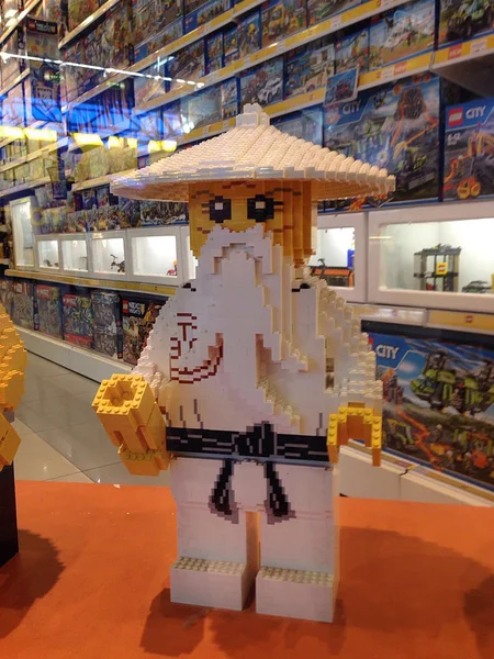 Moscow, Russia - June 13, 2016: Lego figure asian old mink with white beard and black belt in a toy store. Legos are a popular line of plastic construction toys.