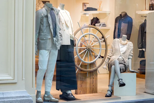 Moscow, Russia - June 14, 2016: The window of Brunelli Cucinelli store. Boutique window with dressed mannequins and steering wheel