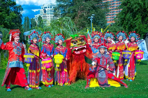 Moscow, Russia - July 31, 2016: Chinese show Golden Dragon Drumpst in the open air during the celebration of the international tiger day in Moscow. Group of artists with chinese lion.