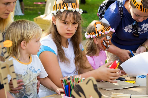 Moscow, Russia - July 31, 2016: children in tiger costumes draw and create crafts during the celebration of the international tiger day in Moscow.