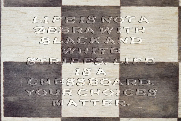 LIFE - IS NOT OF A ZEBRA BLACK AND WHITE STRIPES, LIFE IS A CHESS BOARD. YOUR CHOICES MATTER. Inspiration quote on a wooden chess board. Uneven transparent font.