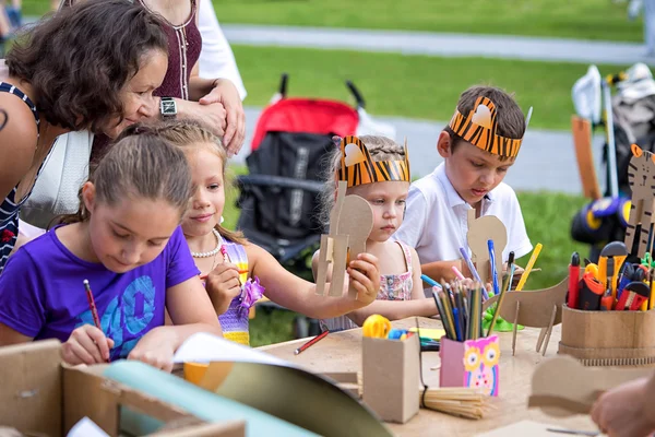 Moscow, Russia - July 31, 2016: children in tiger costumes draw and create crafts during the celebration of the international tiger day in Moscow.