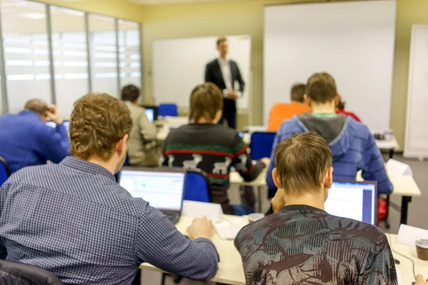 People sitting rear at the computer training class