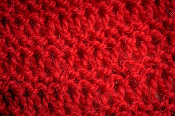 Knitted pattern of red woolen scarf
