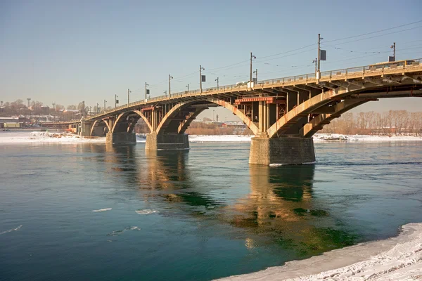 Old reinforced concrete Glazkovsky bridge built in 1931-1936 years across the river Angara in town Irkutsk, Russia, Siberia. River Angara never covered with ice, even in the most severe frosts.