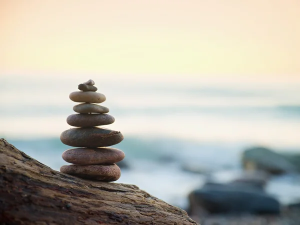 Balanced stone pyramide on sea shore