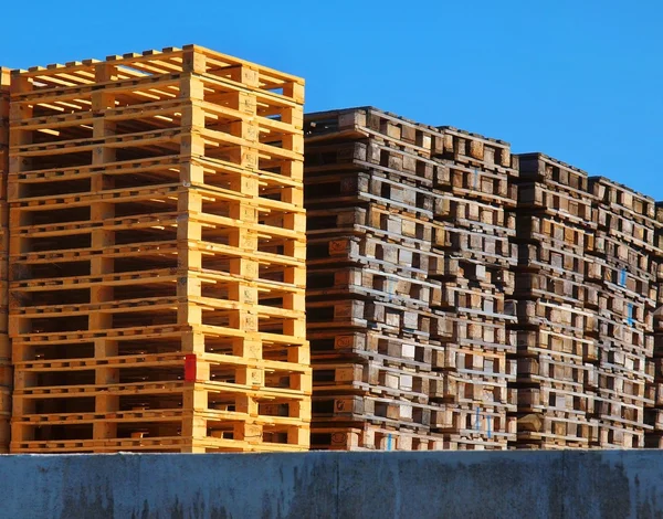 New wooden euro pallets stocked outside at transportation company, stored pallets