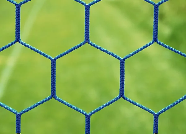Blue crossed soccer football in goal net, thin rope