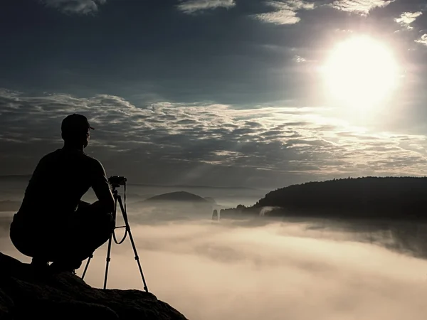 Photographer work with camera on peak. Dreamy mood in landscapelandscape,