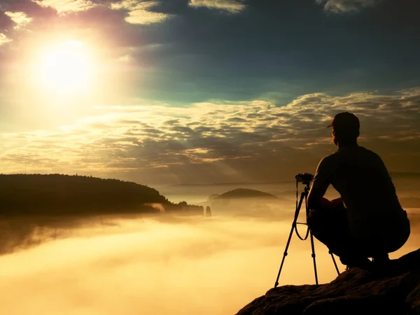Photographer work with camera on peak. Dreamy mood in landscapelandscape,