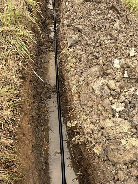 Building of lines of metallic and fiber optic cables.  Laying underground tow network connection cable.