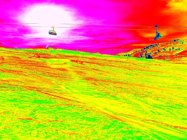 The cab lift above slope in Alps ski region. Sunny winter day, huge of snow. Infrared photo in magic thermography colors.