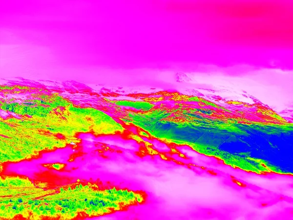 Rapid stream in mountains in infrared photo. Amazing thermography. Hilly landscape in background.