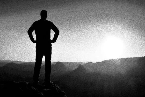 Black and white dashed retro sketch. A man has his hands on  hips. Sportsman  silhouette in nature.