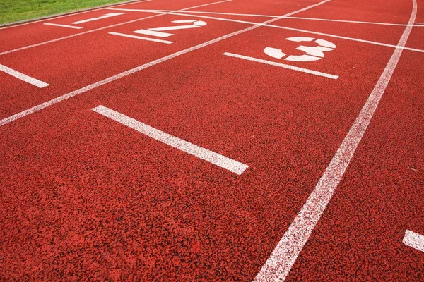 Start. Red running racetrack on the outdoor athletic stadium