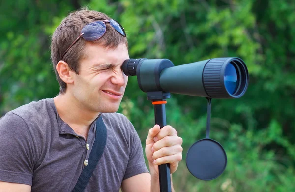 Man who is watching in spotting scope.