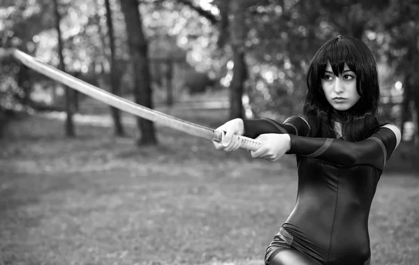Young girl holding samurai sword. Original cosplay character
