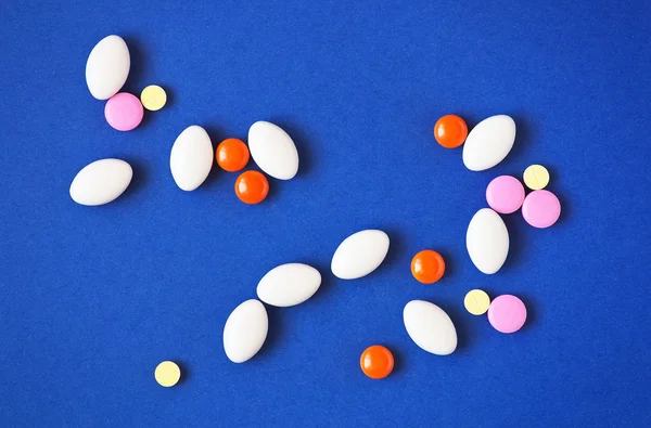 Medicine pills on blue background. Drug prescription for treatme