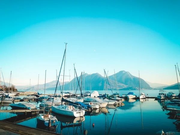 Yachts on the lake, idylic tranquil landscape with mountains.