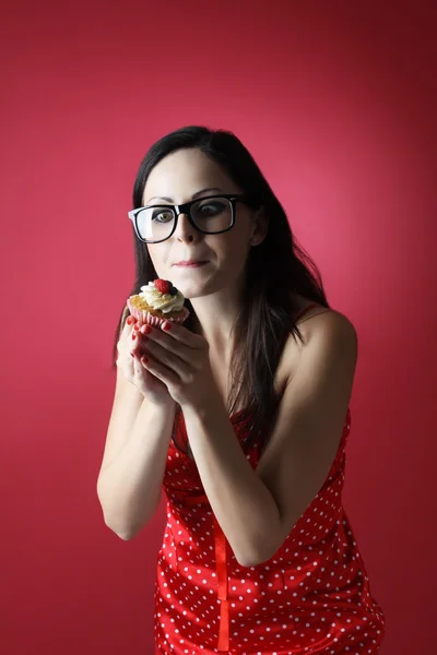 Sweet life with cupcake for young beautiful woman on red background - diet program