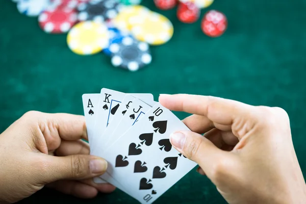 Gambling Hand Holding Best Game Card Series and Money Chips
