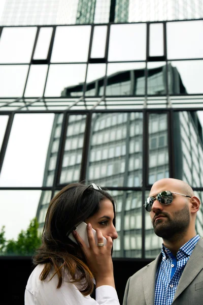 Business Man and Woman Working Outdoor and Glass Building