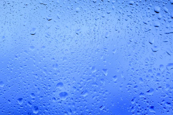 Look at the bright blue through the glass with raindrops