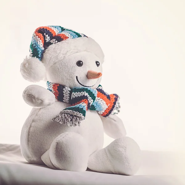 Toy snowman on a white background