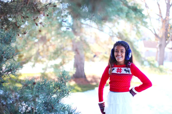 Beautiful tween girl in a winter park