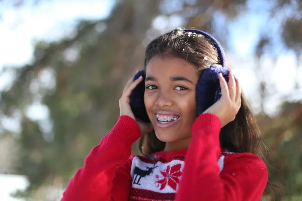 Beautiful tween girl in a winter park