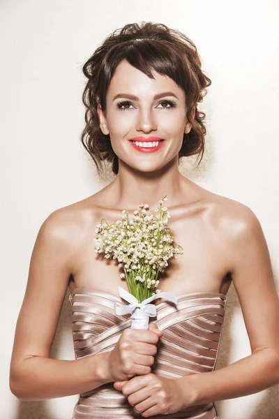 Portrait of Young gorgeous Bride with wedding bouquet