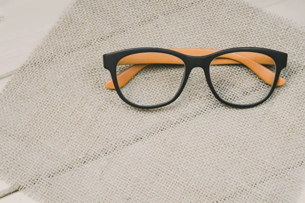 Glasses with Black Frame Fashion on Wood Background