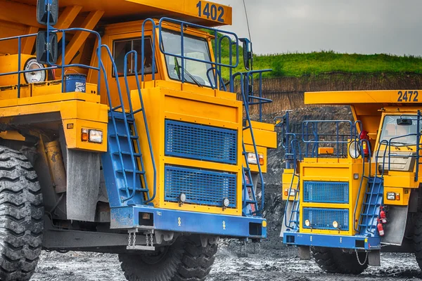 Big yellow mining trucks at worksite