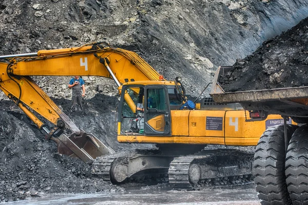 Big yellow mining truck and excavator