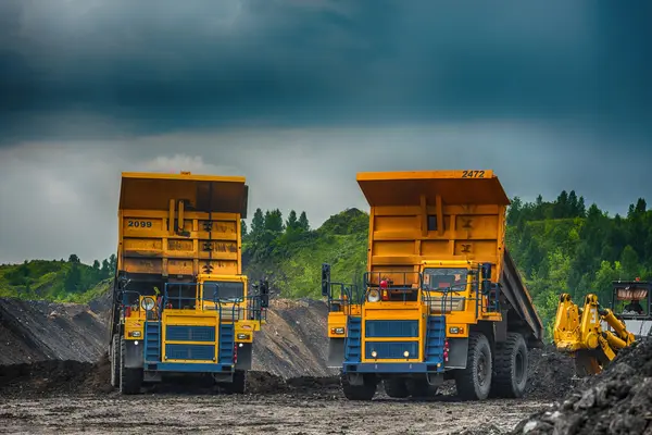 Big yellow mining trucks at worksite