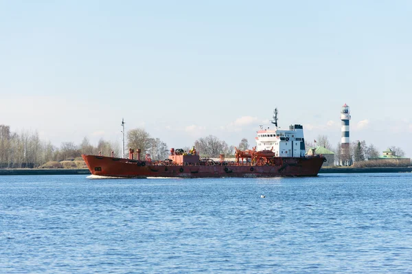 Empty cargo ship entering to port of Riga town in Latvia