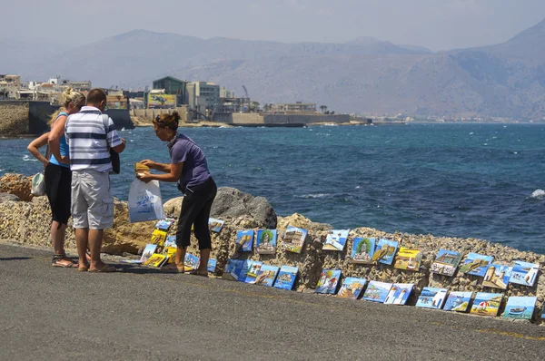 People buy souvenirs near Heraklion coastline. Heraklion is the capital city of Crete island, Greece