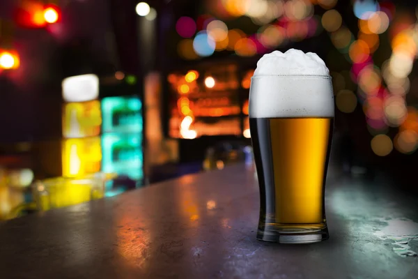 Glass of beer with bar scene
