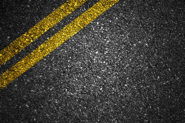 Asphalt road with yellow stripes