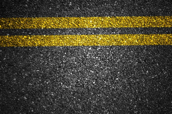 Asphalt road with yellow stripes