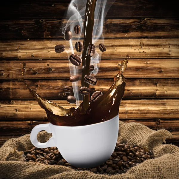 Coffee beans falling in Hot Coffee Cup